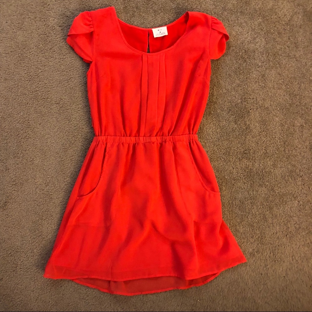 Bright coral dress. Open back detail, pockets.